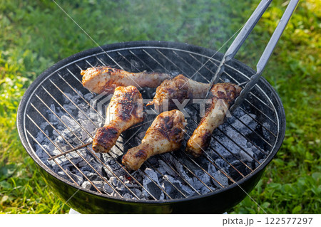 chicken legs are grilled in garden chicken legs are grilled in garden 122577297