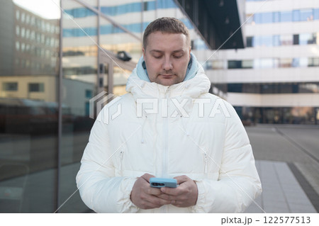 Person using smartphone outdoor winter on city street Person using smartphone outdoor winter on city street 122577513