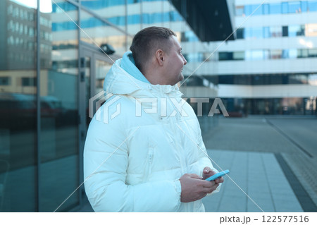 Person using smartphone outdoor winter on city street Person using smartphone outdoor winter on city street 122577516