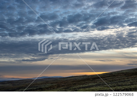 Hill and a sunset cloudscape, Iceland 122579068