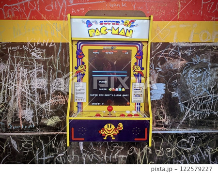 Vintage Super Pac-Man Arcade with Chalk Art Backdrop Eye Level View 122579227