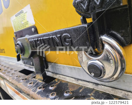 Industrial Yellow Door Lock Mechanism Close-Up Eye-Level Perspective Industrial Yellow Door Lock Mechanism Close-Up Eye-Level Perspective 122579421
