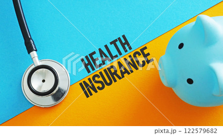 A stethoscope and a piggy bank as a symbol of health insurance. A stethoscope and a piggy bank as a symbol of health insurance. 122579682