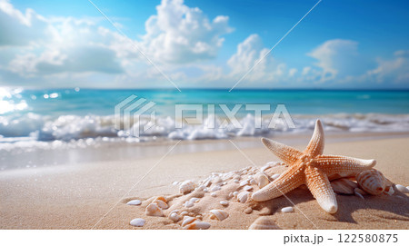Starfish and seashells on a sandy beach under a bright sky near the ocean 122580875