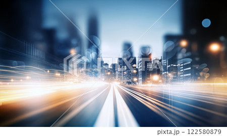 City skyline at dusk with light trails from moving vehicles on a busy highway 122580879
