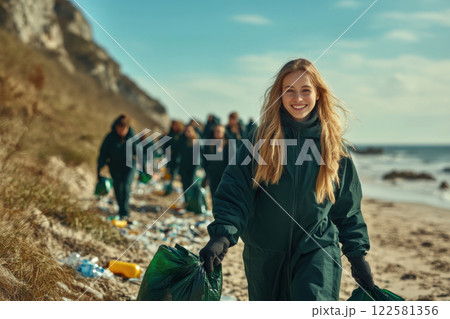 Community beach cleanup coastal area environmental action outdoor setting upbeat view conservation efforts Community beach cleanup coastal area environmental action outdoor setting upbeat view conservation efforts 122581356