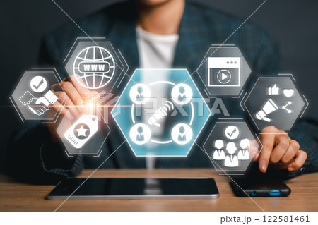 Business professional using digital interface for influencer marketing strategy with social media icons and network connections. 122581461