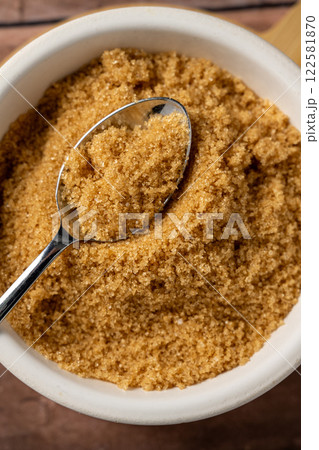 Closeup light brown granulated sugar in a bowl. Closeup light brown granulated sugar in a bowl. 122581870