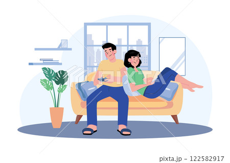 Young Couple Sitting On The Sofa Playing A Game 122582917