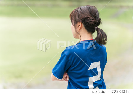 サッカーを観戦するユニフォーム姿の女性 122583813