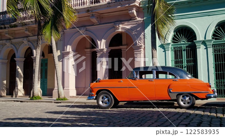 Orange vintage car parked in Havana, Cuba Orange vintage car parked in Havana, Cuba 122583935
