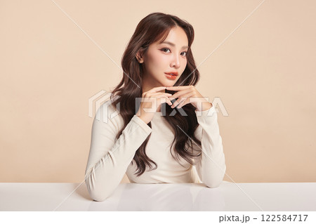 Beautiful young asian woman with clean fresh skin on beige background, Face care, Facial treatment, Cosmetology, beauty and spa, Asian women portrait. 122584717
