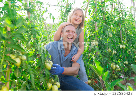 Dad and daughter gardening together 122586428