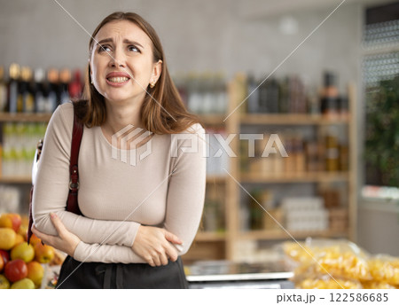 Young woman felt unwell and had abdominal pain while shopping. 122586685