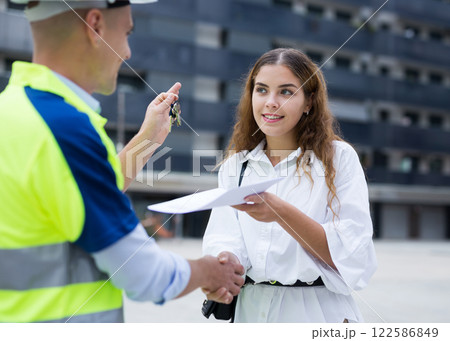 Client shaking hand with builder after signing contract Client shaking hand with builder after signing contract 122586849