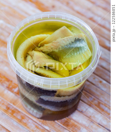 In plastic bucket containers are large pieces of salted herring fillet, freed from bones In plastic bucket containers are large pieces of salted herring fillet, freed from bones 122586851