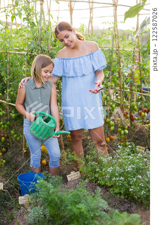 Mother and daughter in garden Mother and daughter in garden 122587026