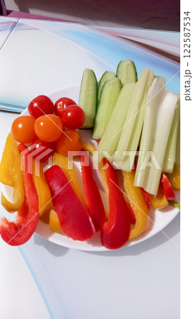 Fresh vegetables on a plate peppers tomatoes cucumbers and celery 122587534