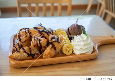 Ice cream chocolate waffle with whipping cream and bananas. 122587863