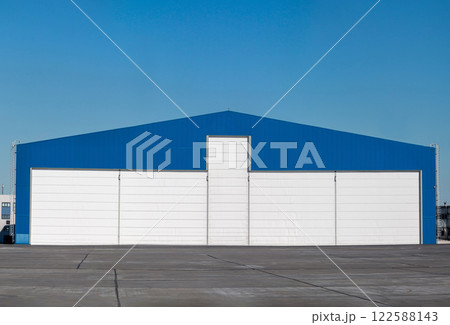 Aviation hangar outside on a clear day Aviation hangar outside on a clear day 122588143