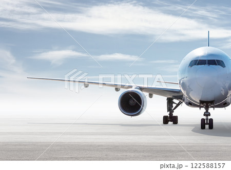 Front view of wide body passenger aircraft isolated on bright background with sky Front view of wide body passenger aircraft isolated on bright background with sky 122588157