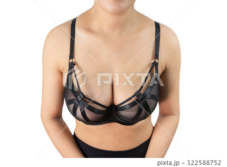 Woman with beautiful breasts, black bra isolated on white background, closeup. 122588752