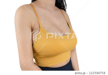 Woman with beautiful breasts sexy sport bra a yellow on a white background, closeup. Woman with beautiful breasts sexy sport bra a yellow on a white background, closeup. 122588758