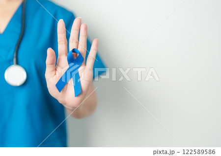 March Colorectal Cancer Awareness month, doctor with dark Blue Ribbon for supporting people living and illness. Healthcare, hope and World cancer day concept March Colorectal Cancer Awareness month, doctor with dark Blue Ribbon for supporting people living and illness. Healthcare, hope and World cancer day concept 122589586