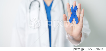 March Colorectal Cancer Awareness month, doctor with dark Blue Ribbon for supporting people living and illness. Healthcare, hope and World cancer day concept March Colorectal Cancer Awareness month, doctor with dark Blue Ribbon for supporting people living and illness. Healthcare, hope and World cancer day concept 122589604