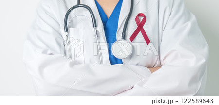 Doctor with Burgundy Red Ribbon for March multiple myeloma Cancer and December World Aids Day Awareness month. Healthcare and world cancer day concept Doctor with Burgundy Red Ribbon for March multiple myeloma Cancer and December World Aids Day Awareness month. Healthcare and world cancer day concept 122589643