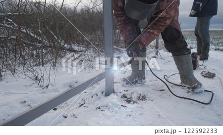 Professional worker performs welding work 122592233