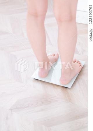 体重計に乗る若い女性　顔無し 122593763