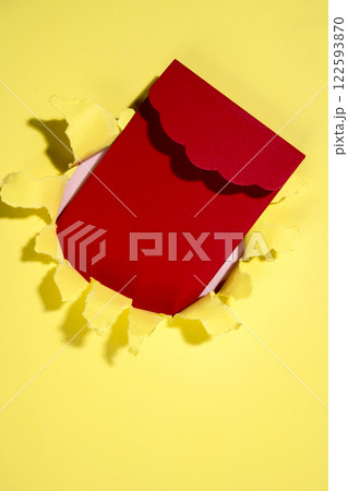 Red envelope from the hole of ripped paper. Mockup or Copy space. Template. Greetings or invitation. Concept of message or communication 122593870