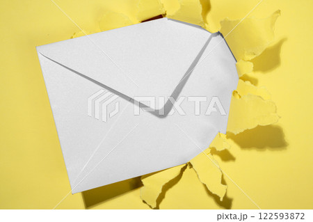 Envelope from the hole of ripped paper. Mockup or Copy space. Template. Greetings or invitation. Concept of message or communication 122593872