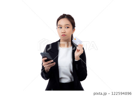 Portrait young asian businesswoman holding credit card and smartphone while thoughtful isolated. 122594896