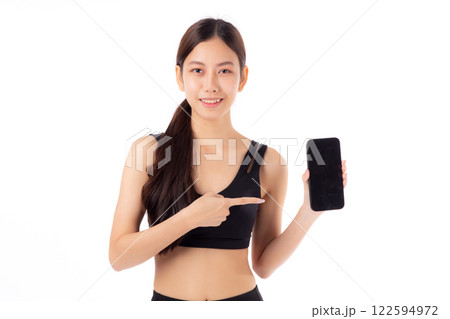 Young asian woman in sportswear workout holding and presenting blank screen smartphone isolated. 122594972