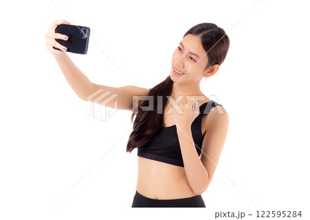 Portrait young asian woman in sportswear workout and selfie on smartphone isolated. 122595284