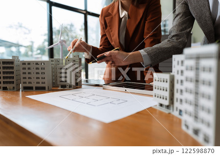 Asian business people using tablet for working technology and business, Renewable energy-based green businesses and global warming. Reduce CO2 emission. 122598870
