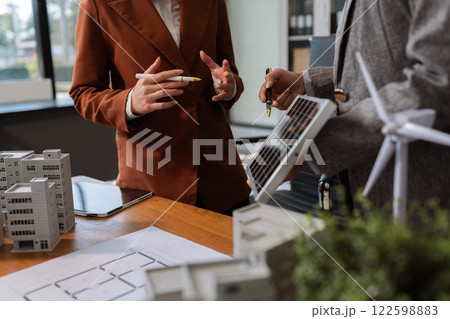 House model with agent asking costumer for contract to buy, get insurance or loan real estate or property. 122598883