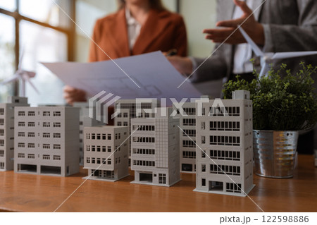 House model with agent asking costumer for contract to buy, get insurance or loan real estate or property. 122598886