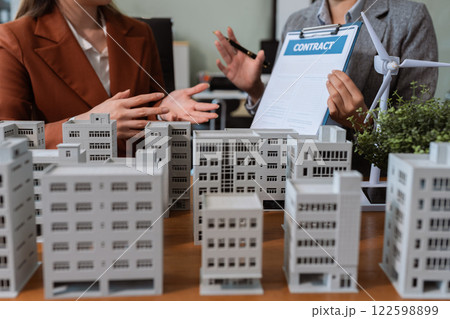 House model with agent asking costumer for contract to buy, get insurance or loan real estate or property. 122598899