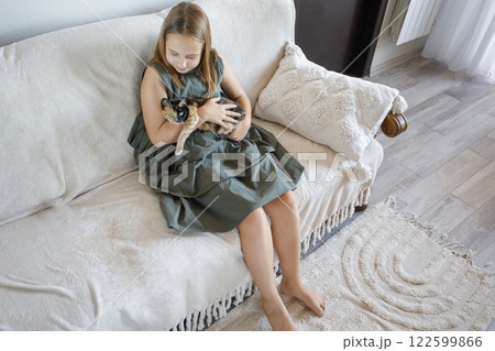 Child playing with cat at home. Friends. Kid and pet. 122599866