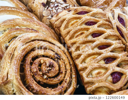Freshly baked pastries displayed in a bakery showcasing a variety of textures and flavors 122600149
