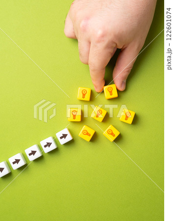 Hand puts blocks with light bulbs ideas. Concept of technological development and ingenuity. Patents. Advancing research, intellectual property protection, and groundbreaking developments. 122601074