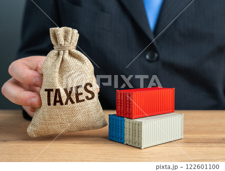 A businessman holds a bag of taxes received from trade and import duties. Government income, taxation policies, and economic growth through regulated trade. 122601100