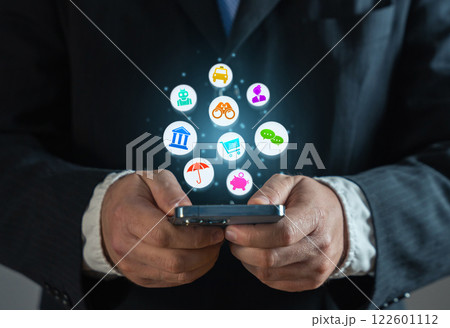 Businessman with a phone and a cloud of various services and mobile applications. Online business promotion and new experience for new customers users. An application that saves time and money. Businessman with a phone and a cloud of various services and mobile applications. Online business promotion and new experience for new customers users. An application that saves time and money. 122601112