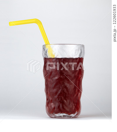 A cold, refreshing berry drink is presented in a glass with a yellow straw A cold, refreshing berry drink is presented in a glass with a yellow straw 122601933