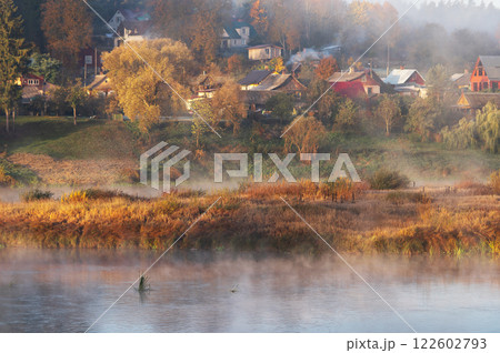 Autumn foggy morning view across river Daugava to roofs of houses of small town Kraslava in Latvia 122602793