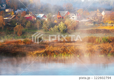 Colorful foggy morning view across river Daugava to roofs of houses of small town Kraslava in Latvia 122602794