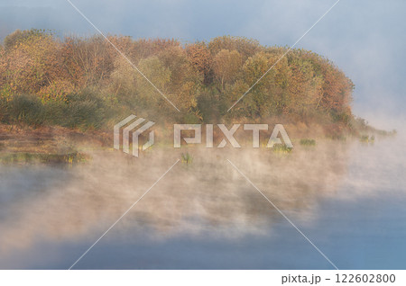Daugava river coasteline in cold autumn morning, fog over the water 122602800